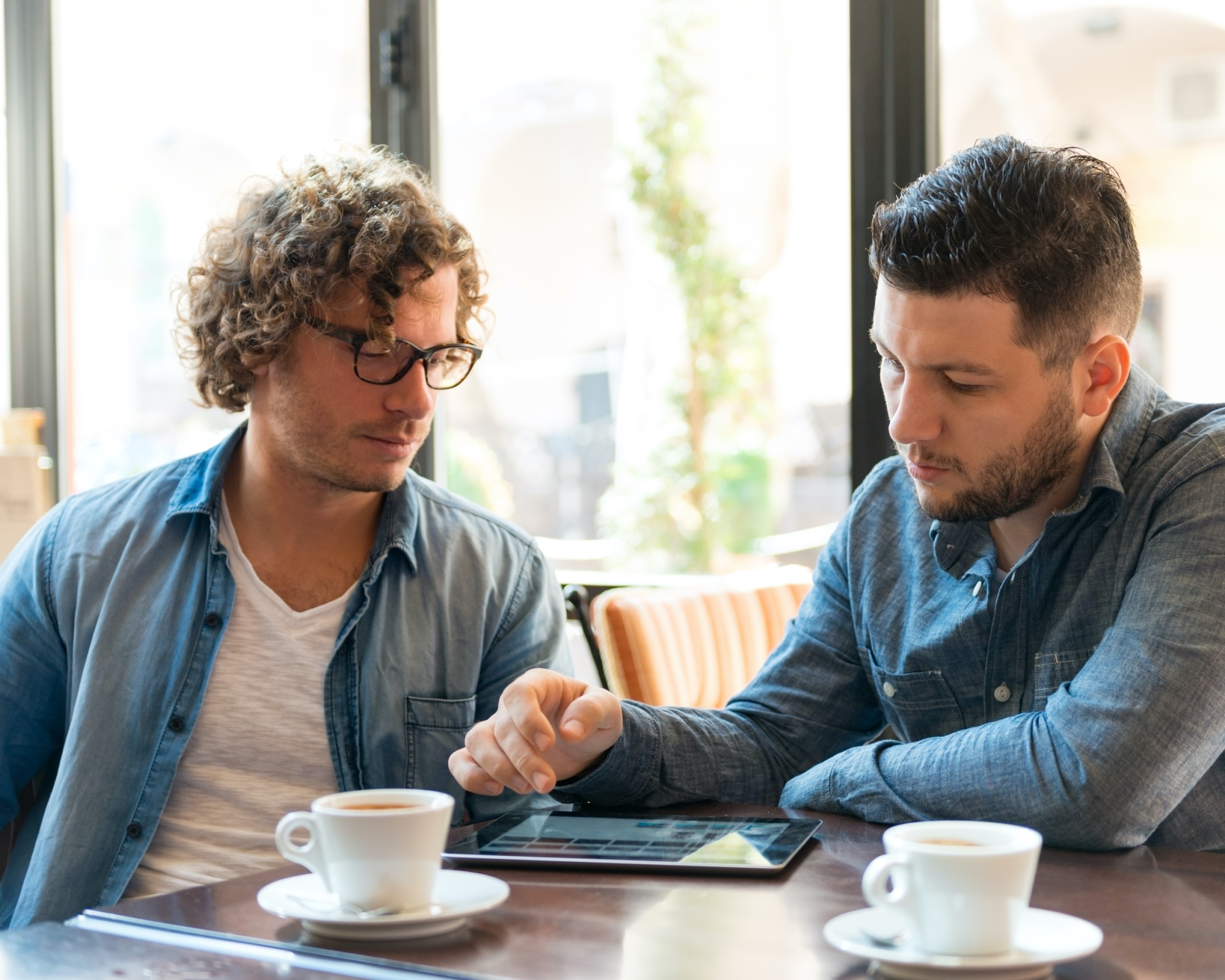 Two men working together in a coffee shop